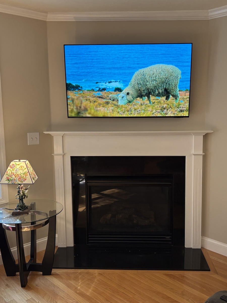 Television mounted above a fireplace in Worcester, MA by J&S Audio Video Solutions
