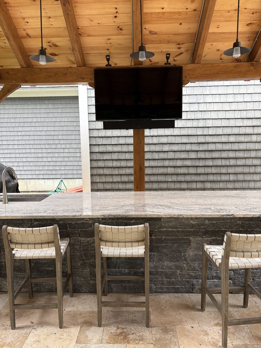 Outdoor television mounted under a timber pavilion in Oakham, MA by J&S Audio Video Solutions