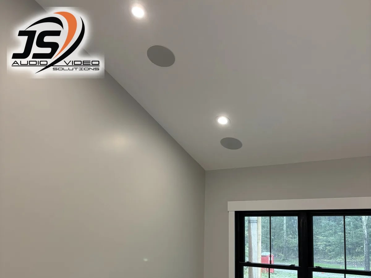 Two flush-mounted ceiling speakers beside a window in a Dudley, MA home by J&S Audio Video Solutions
