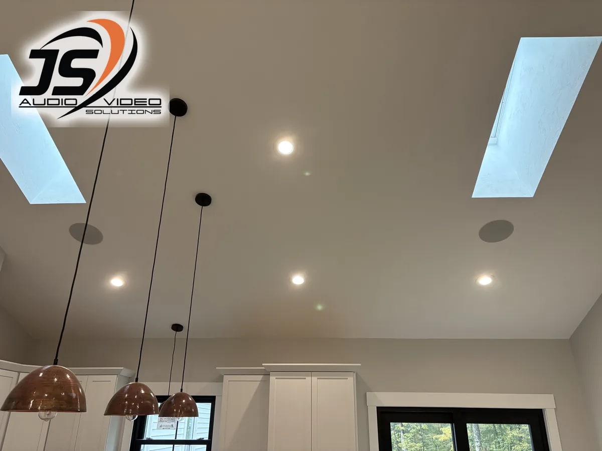 In-ceiling speakers set among recessed lights, skylights, and pendants in a Dudley, MA home by J&S Audio Video Solutions