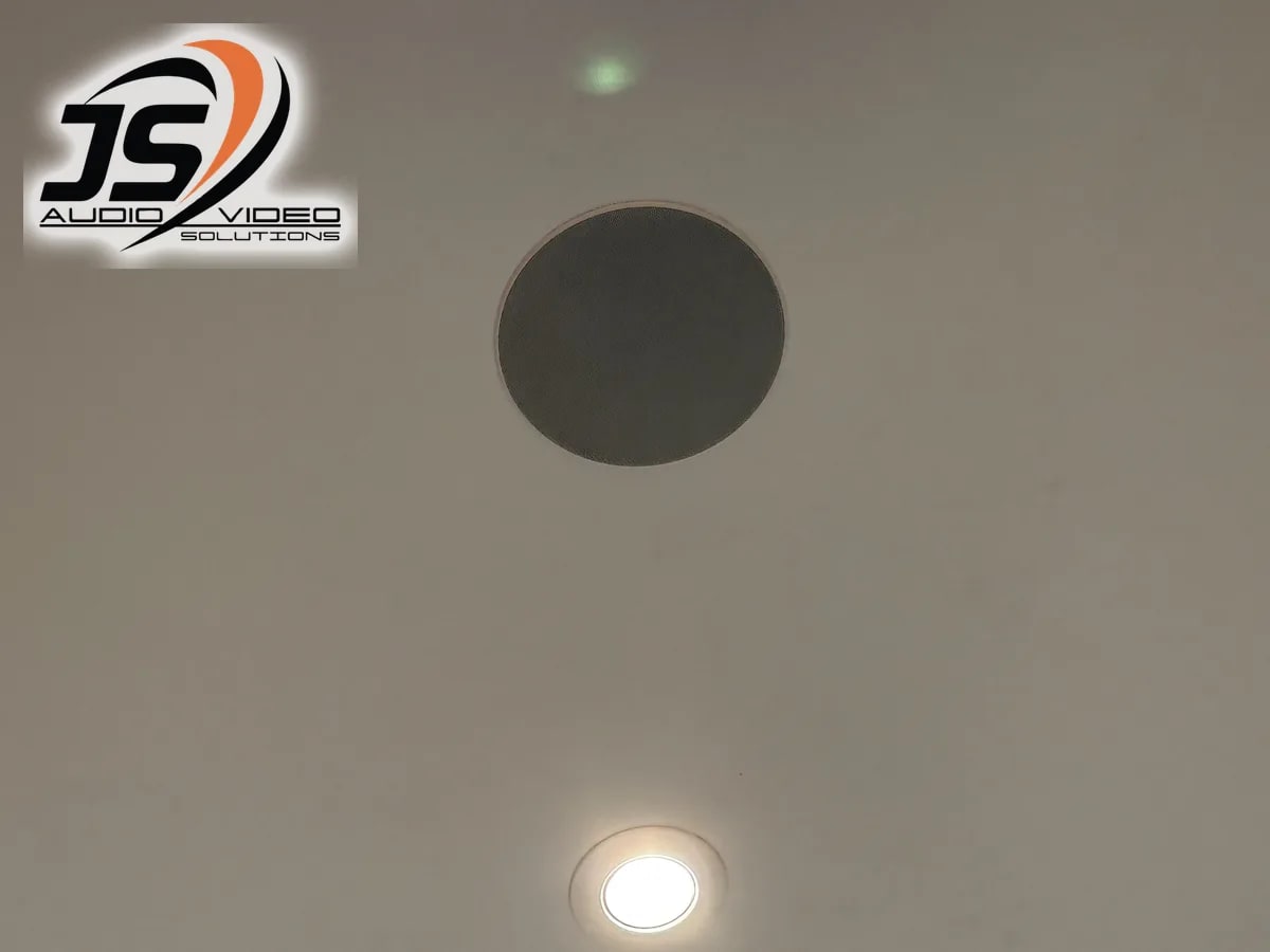 Close view of a flush-mounted in-ceiling speaker in a Dudley, MA home by J&S Audio Video Solutions