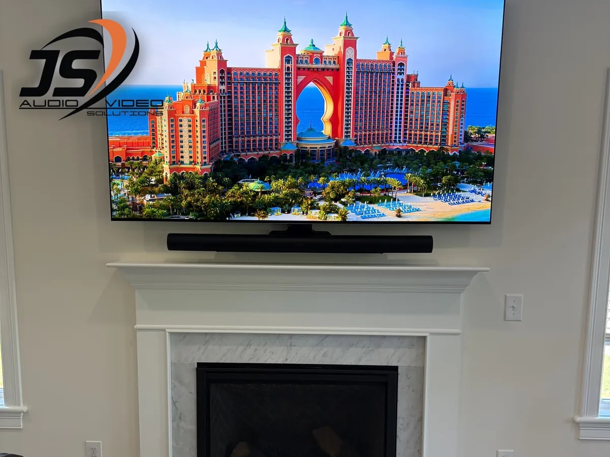 Completed television and soundbar installation above a fireplace in Jefferson, MA by J&S Audio Video Solutions