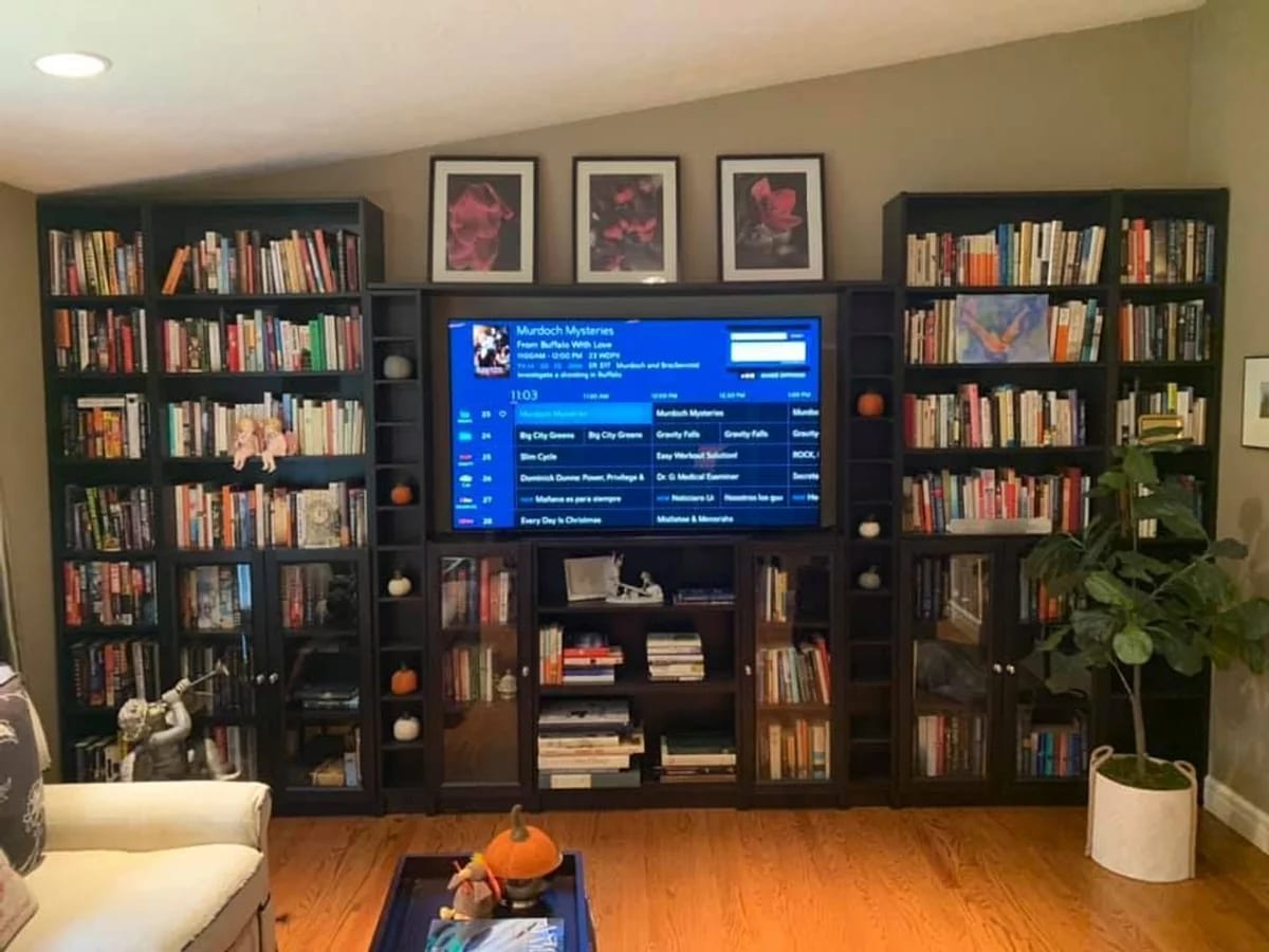 Home theater integrated into living room bookshelves by J&S Audio Video Solutions